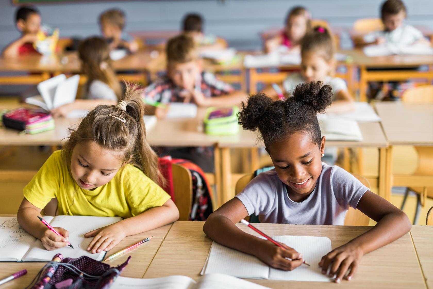 Young girls at school desk
